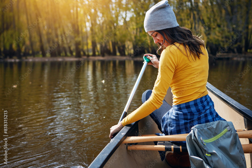 Woman, back and canoeing in nature on river, wellness hobby and backpack for supplies with paddle for rowing. Vacation, relax and explore exercise on travel holiday, canoe boat and trees on lake