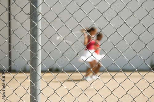 Girls Skipping Beyond A Fence