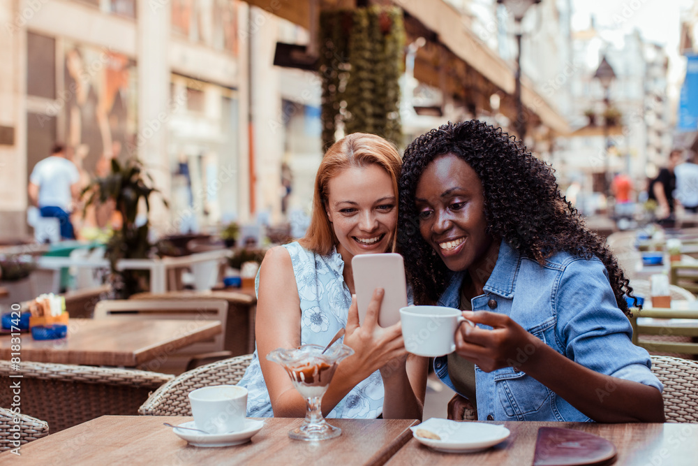 Two young women taking selfie in street cafe Two young women taking selfie in street cafe