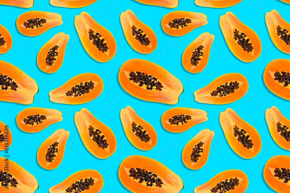 seamless pattern of sliced papayas on blue background seamless pattern of sliced papayas on blue background