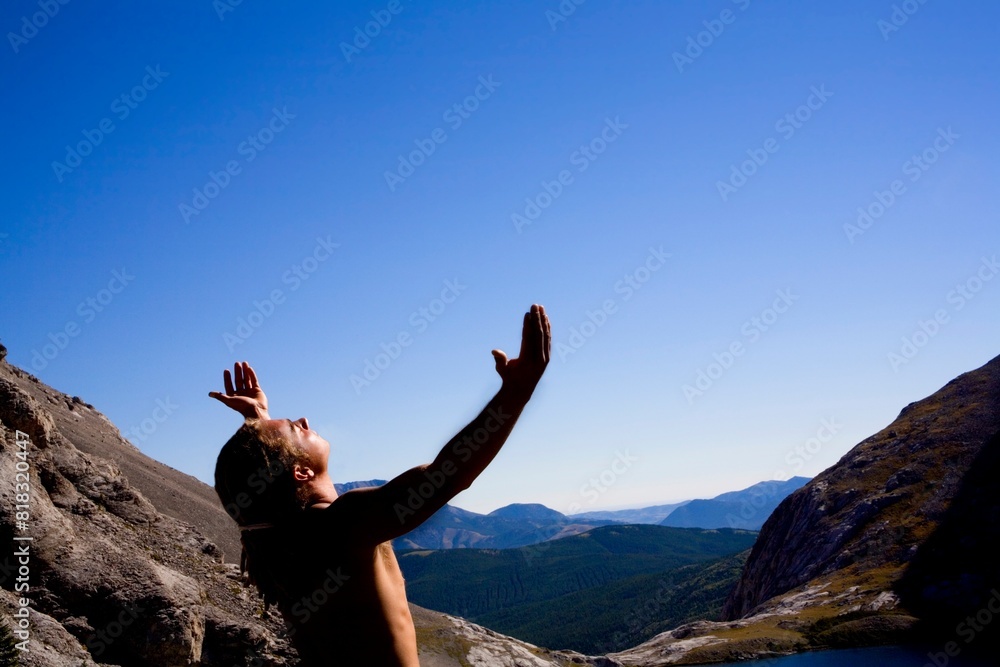 Young Man Worshipping On Mountain Top Young Man Worshipping On Mountain Top