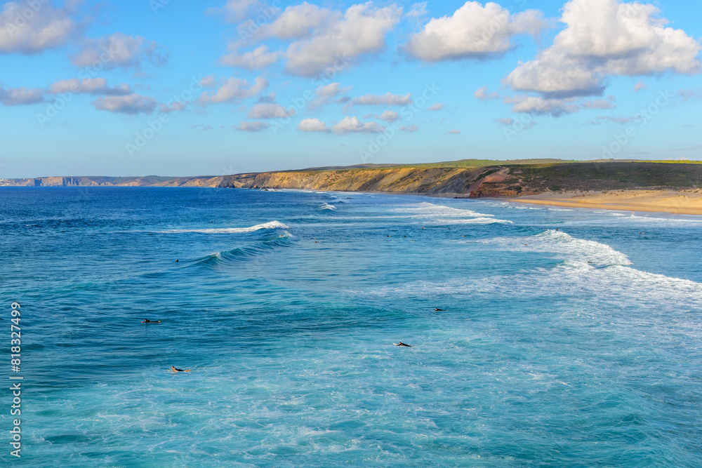 Atlantic ocean coastline and beach popular among surfers and tourists in Praia da Bordeira, Algarve, Portugal