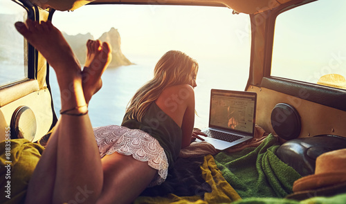 Car, travel and woman with laptop for relax, sunset and remote worker for road trip. Transport, technology and internet for email or online work in boot, female person or calm for ocean side vacation