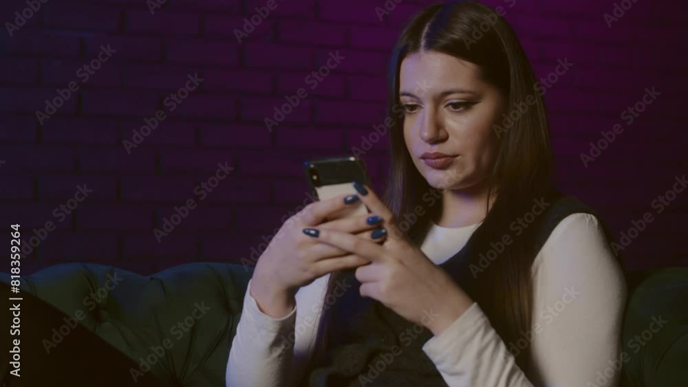 Bored adult young woman lying on divan at home and surfing news feed in smartphone. Young lady after job using phone on couch. Tired woman laying on divan and check her social medias Bored adult young woman lying on divan at home and surfing news feed in smartphone. Young lady after job using phone on couch. Tired woman laying on divan and check her social medias