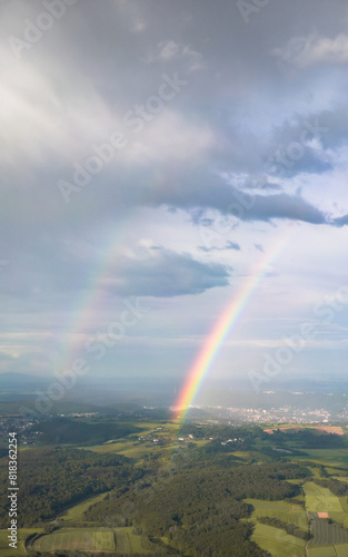 Aerial view of two rainbows over the hills in the countryside