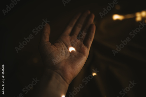 Softly illuminated hand capturing a glimpse of light photo