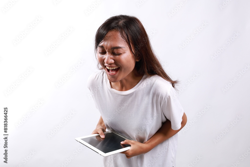 young millennial asian woman holding a digital tablet, received funny news jokes. Laughing lot, isolated on white background. young millennial asian woman holding a digital tablet, received funny news jokes. Laughing lot, isolated on white background.