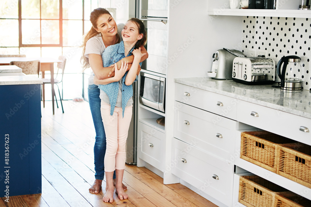 Smile, mom and girl with embrace in family home for bonding, love and connection together on weekend. Kitchen, hug and woman with daughter in house for care, support or affection in child development Smile, mom and girl with embrace in family home for bonding, love and connection together on weekend. Kitchen, hug and woman with daughter in house for care, support or affection in child development