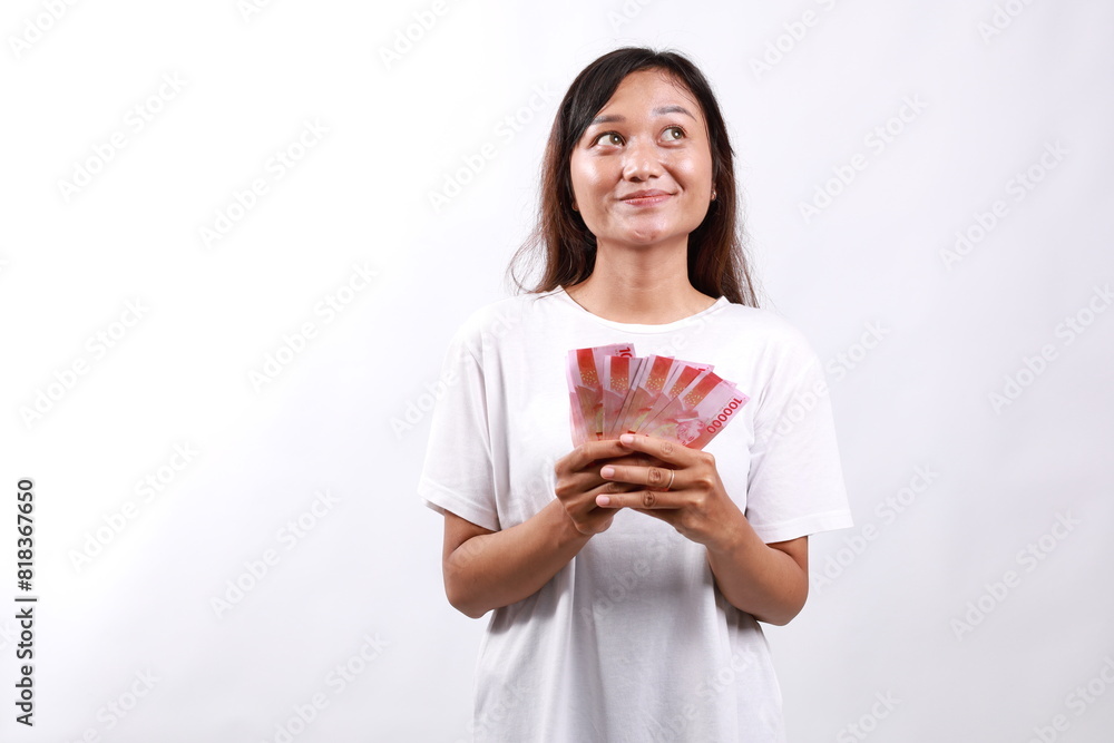 Dreamy pleased woman thinking where go vacation and how invest earned money, hold cash and looking up thoughtful. Business, finance and employment, entrepreneur and money concept Dreamy pleased woman thinking where go vacation and how invest earned money, hold cash and looking up thoughtful. Business, finance and employment, entrepreneur and money concept