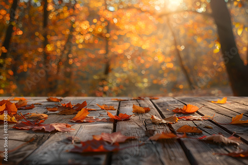 Wooden table with orange leaves autumn background