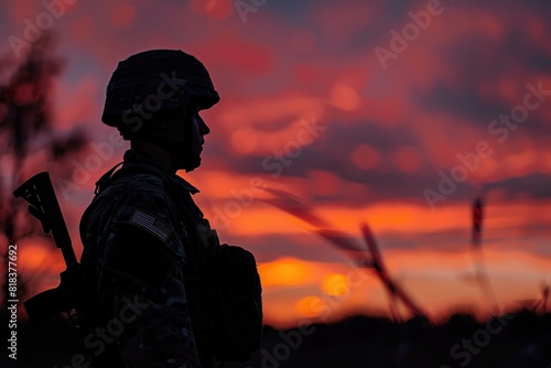 soldier's silhouette against the sky on sunset © Elena