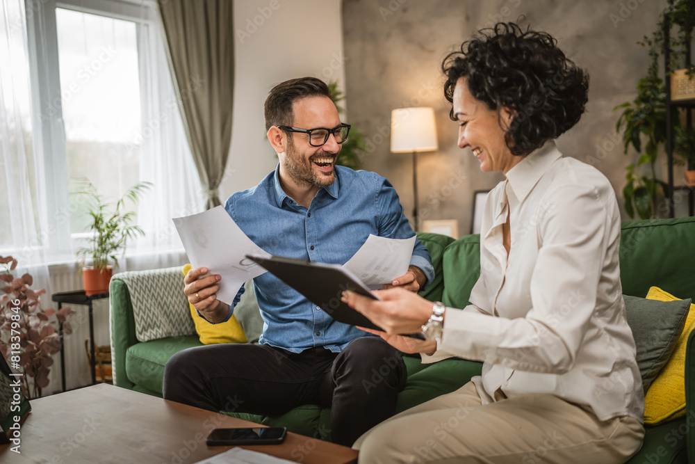 Obraz premium Two colleagues man and woman work on economy project together at home