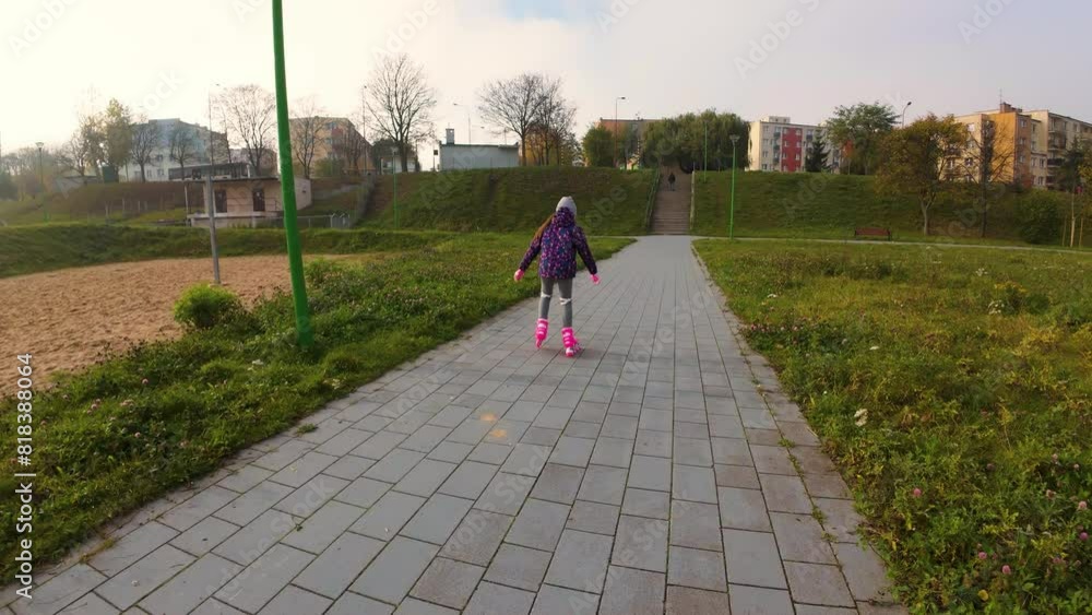 Girl Rollerblading outdoors in city park. Kid enjoying active sport, wide angle view. Cheerful carefree young girl rollerblading along city park Girl Rollerblading outdoors in city park. Kid enjoying active sport, wide angle view. Cheerful carefree young girl rollerblading along city park
