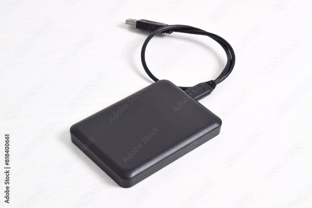External Hard Disk drive with usb cable isolated on white background. External HDD with usb connector External Hard Disk drive with usb cable isolated on white background. External HDD with usb connector