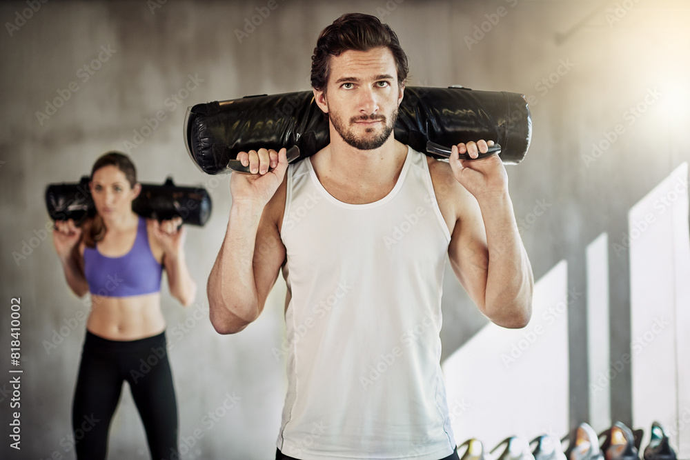 People, fitness and sandbag exercise for gym training or weightlifting for muscle growth, workout or friends. Man, woman and personal trainer with equipment as athlete teamwork, sports or activity People, fitness and sandbag exercise for gym training or weightlifting for muscle growth, workout or friends. Man, woman and personal trainer with equipment as athlete teamwork, sports or activity