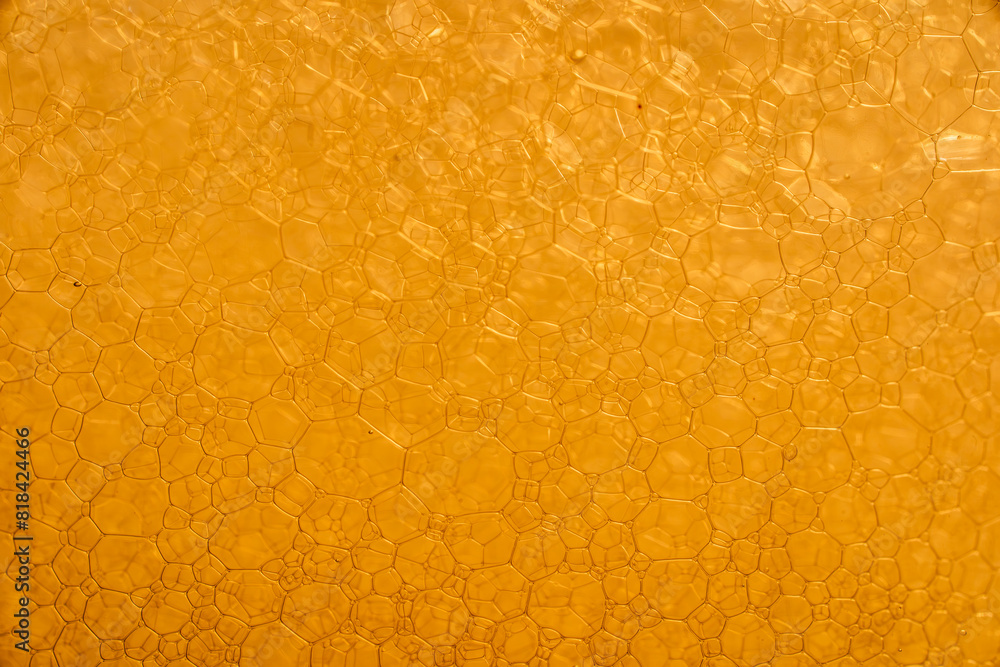 Closeup macro shot of foam bubbles in yellow water Closeup macro shot of foam bubbles in yellow water