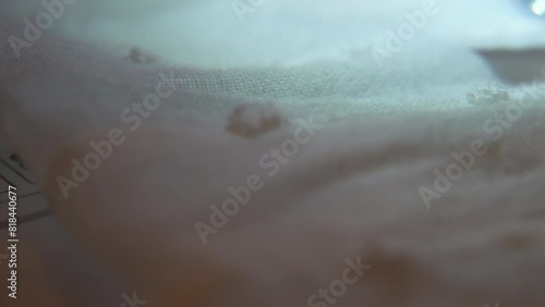 travelling image showing the fabric and the sewing machine stitching