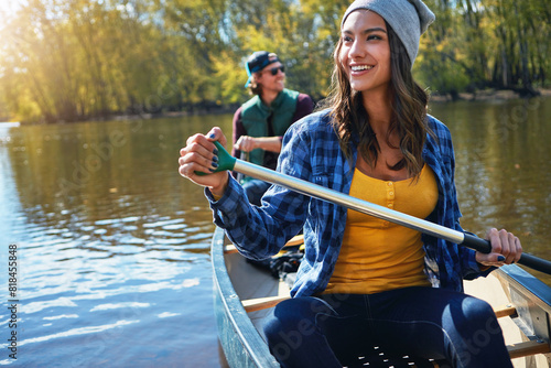 Couple, canoeing and lake for outdoor holiday exploring or rowing adventure, environment or journey. Man, woman and travel weekend on river for Colorado vacation with forest exercise, island or hobby
