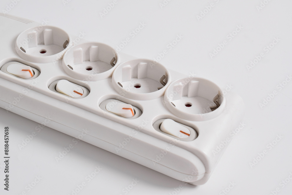 White Electrical plug in outlet socket at home isolated on white background, Power strip extension, electrical extension cord, with four sockets, a power button and a connected electrical plug White Electrical plug in outlet socket at home isolated on white background, Power strip extension, electrical extension cord, with four sockets, a power button and a connected electrical plug