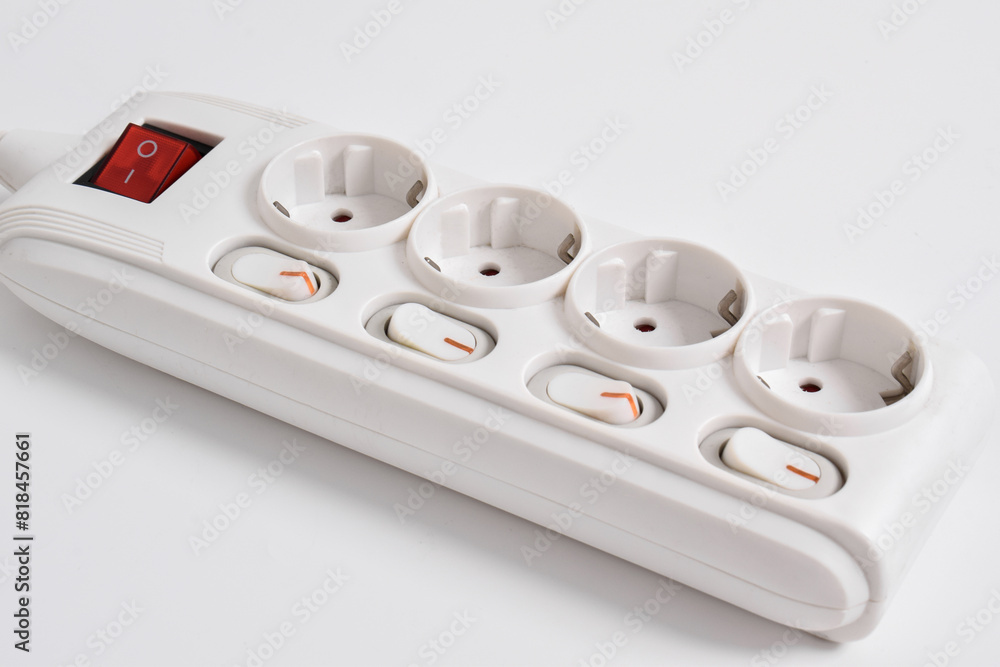 White Electrical plug in outlet socket at home isolated on white background, Power strip extension, electrical extension cord, with four sockets, a power button and a connected electrical plug White Electrical plug in outlet socket at home isolated on white background, Power strip extension, electrical extension cord, with four sockets, a power button and a connected electrical plug