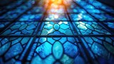 A close up of a stained glass window with a blue hue. The window is filled with many small blue shapes