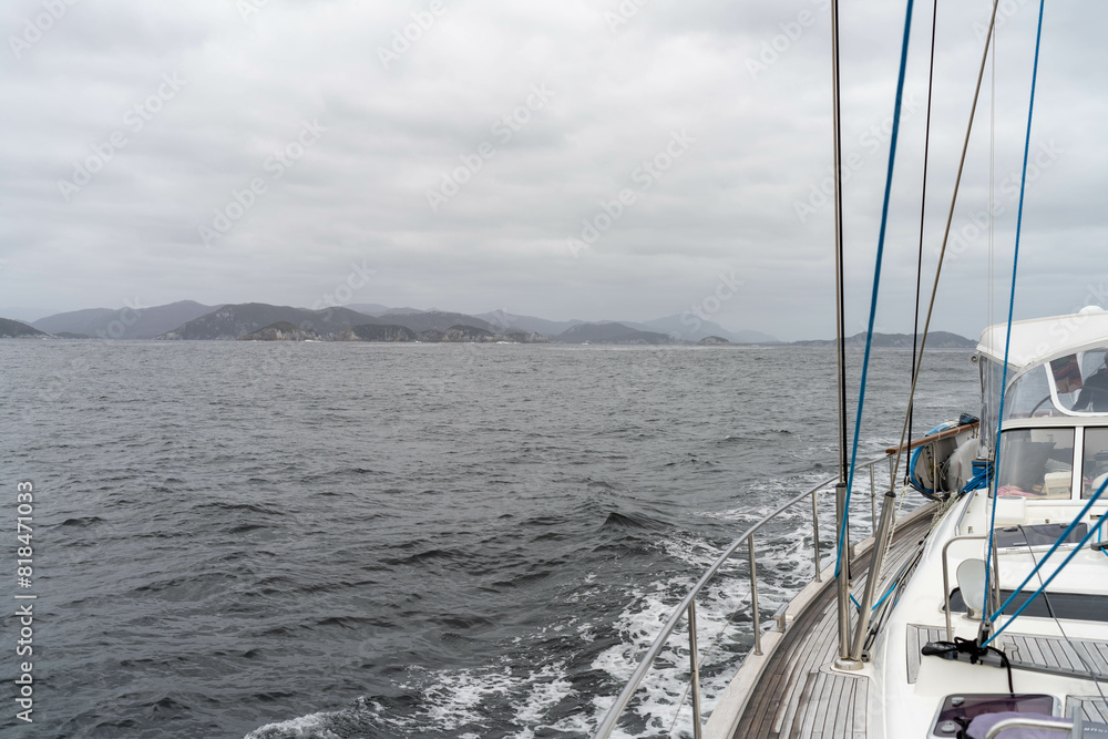 sailing on a yacht in the australian in the remote forest wilderness in spring in australia with waves breaking sailing on a yacht in the australian in the remote forest wilderness in spring in australia with waves breaking