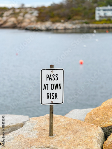 Coastal Caution: Pass at Own Risk Sign by Sea View