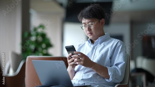 businessman using mobile phone in open office