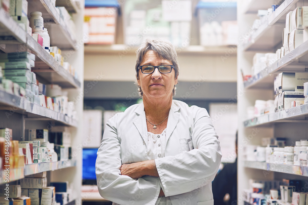 Mature, woman and portrait of pharmacist in shop with inventory of drugs, pills or medicine. Pharmacy, store and sale of medical product with healthcare supplements or chemist with arms crossed Mature, woman and portrait of pharmacist in shop with inventory of drugs, pills or medicine. Pharmacy, store and sale of medical product with healthcare supplements or chemist with arms crossed