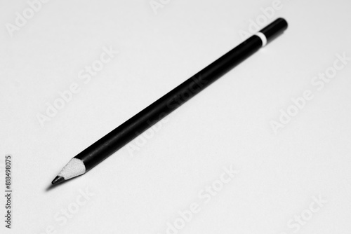 Black pencil on a white sheet of paper.