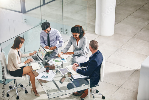 Team, business people and manager with laptop on table for financial meeting, pitch or presentation. Group, accountant and collaboration in office with computer for investment, documents for strategy