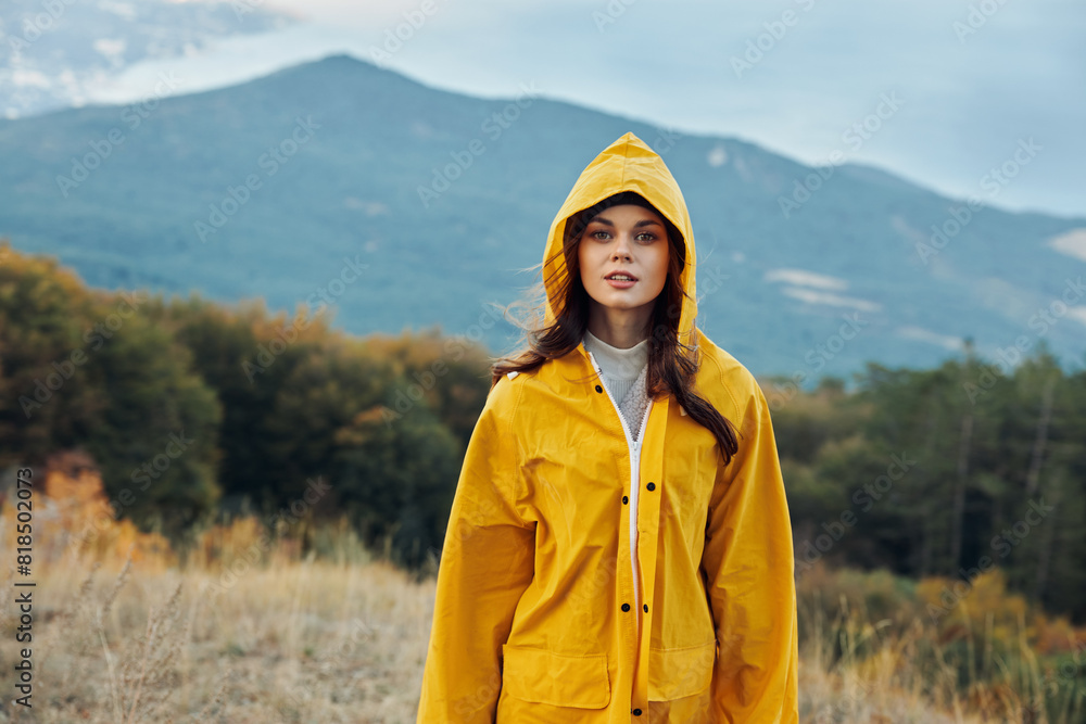 Woman in Yellow Raincoat Standing in Serene Field with Majestic Mountain Background A Snapshot of Nature's Beauty Woman in Yellow Raincoat Standing in Serene Field with Majestic Mountain Background A Snapshot of Nature's Beauty