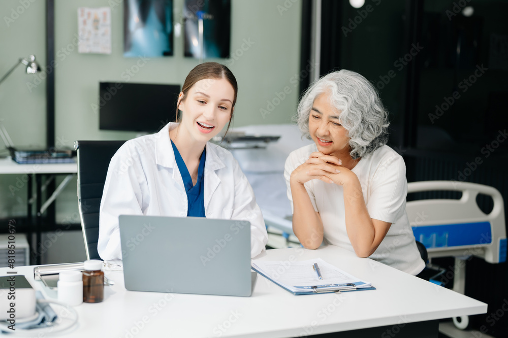 Obraz premium Doctor discussing treatment with male patient talking and laughing sitting on examination bed in clinic or hospital.
