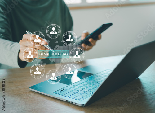 Stakeholders concept. Person touching stakeholders icon on virtual screen for business finance stakeholder investment management. Different stakeholders contact collaboration for company organization
