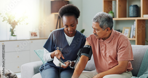 Elderly man, living room and nurse with blood pressure for heart rate, cardiovascular support or exam. Senior person, healthcare and medical machine on sofa for hypertension, results and consultation