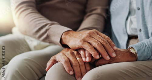 Holding hands, senior and couple with support in living room, empathy and love with care on couch. Lounge, marriage and people, elderly and retirement in house or apartment with compassion in home photo