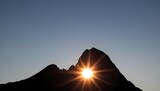 A mountain silhouette with a sun setting behind it upscaled_5