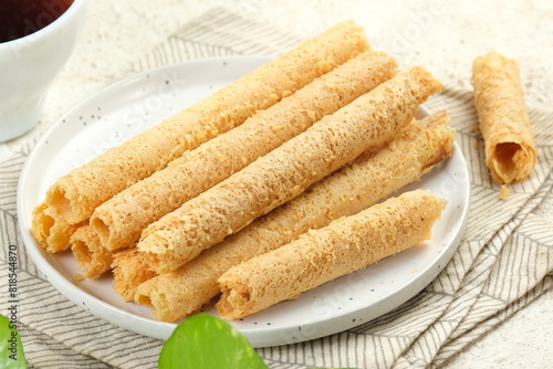 Egg Roll Biscuit or Kue Semprong or sapit, Simping, kue Belanda, or kapit or Love letters in English. It is an Indonesian traditional wafer snack photo