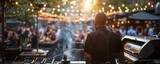 What kind of music is playing on stage at a bustling outdoor grilling event, and how does it enhance the overall ambiance