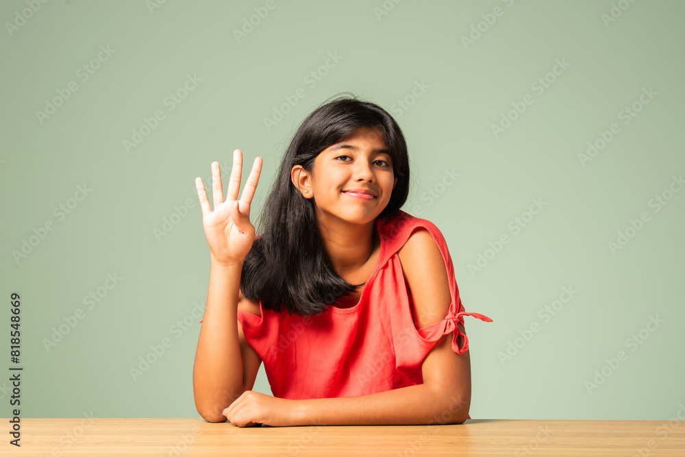 Asian Indian adorable little girl counting using fingers Asian Indian adorable little girl counting using fingers