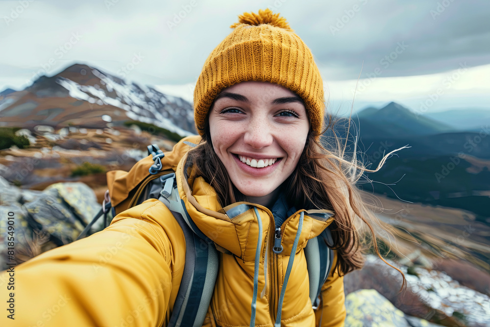 Young hiker taking a selfie on a mountain top, radiating happiness and a love for outdoor adventures Young hiker taking a selfie on a mountain top, radiating happiness and a love for outdoor adventures