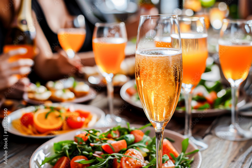 An elegant glass of champagne on a festive table with appetizers, perfect for celebrations and special events. An elegant glass of champagne on a festive table with appetizers, perfect for celebrations and special events.