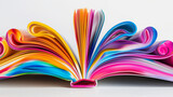 An open book with vividly colored pages curling at the edges, creating a dynamic and artistic display of rainbow-like hues and flowing forms.