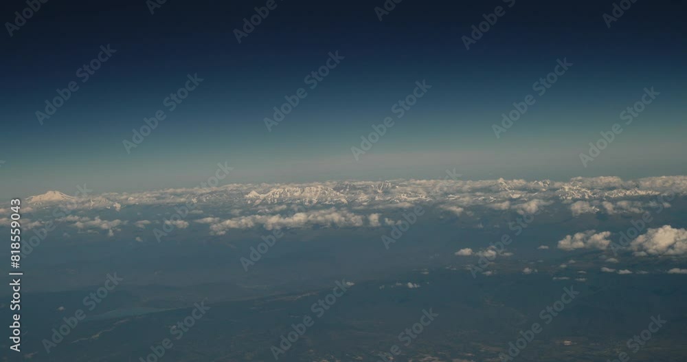 View From Airplane Window On Snow-capped Peaks Of Mount Elbrus And Main Caucasian Range. Travel And Tourism Around World. Elbrus Is Highest Mountain In Europe. Georgian Mountains range. Caucasus. View From Airplane Window On Snow-capped Peaks Of Mount Elbrus And Main Caucasian Range. Travel And Tourism Around World. Elbrus Is Highest Mountain In Europe. Georgian Mountains range. Caucasus.