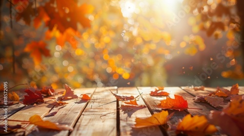 Wooden table with orange fall leaves, autumn natural background