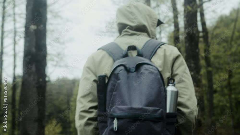 Traveler man with backpack hiking in woods near lake. Traveling alone, weekend activity, nature concept Traveler man with backpack hiking in woods near lake. Traveling alone, weekend activity, nature concept