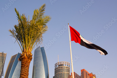 ABU DHABI, UAE - April 22, 2024: Etihad Towers with UAE flag on May 1, 2013 in Abu Dhabi, UAE. Etihad Towers is the name of a complex of buildings with five towers in Abu Dhabi photo