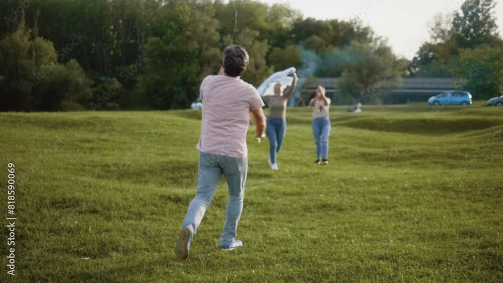 Medium shot of a senior grandparents with adult daughter playing together flying a kite toy on a green meadow in nature Medium shot of a senior grandparents with adult daughter playing together flying a kite toy on a green meadow in nature