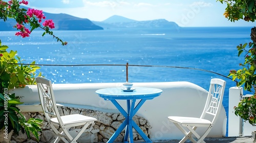 Two white chairs with blue table on the terrace with sea view