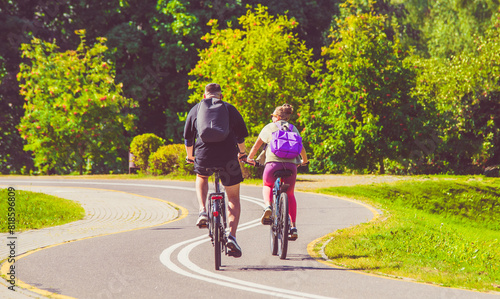 Wallpaper Mural Cyclists ride on the bike path in the city Park
 Torontodigital.ca